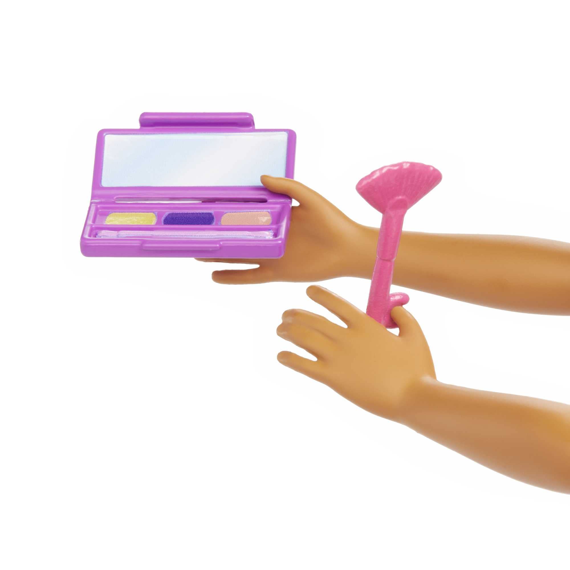 Playful kids makeup set featuring a purple palette, mirror, and pink applicator tool.