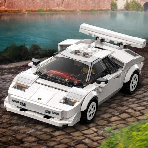 Classic LEGO sports car on a scenic cobblestone path beside a tranquil water body.
