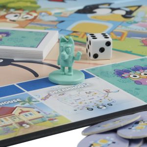 Colorful board game with whimsical characters, mint-green game piece, and dice, inviting fun adventures.