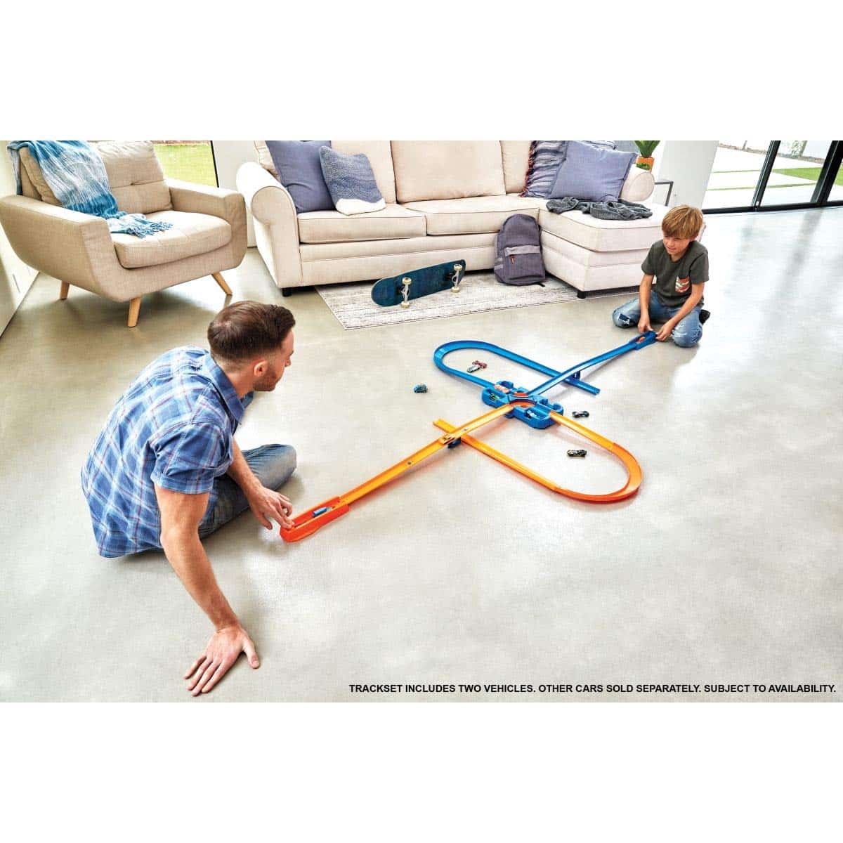 Father and son enjoy creative play with colorful toy tracks in a bright living room.