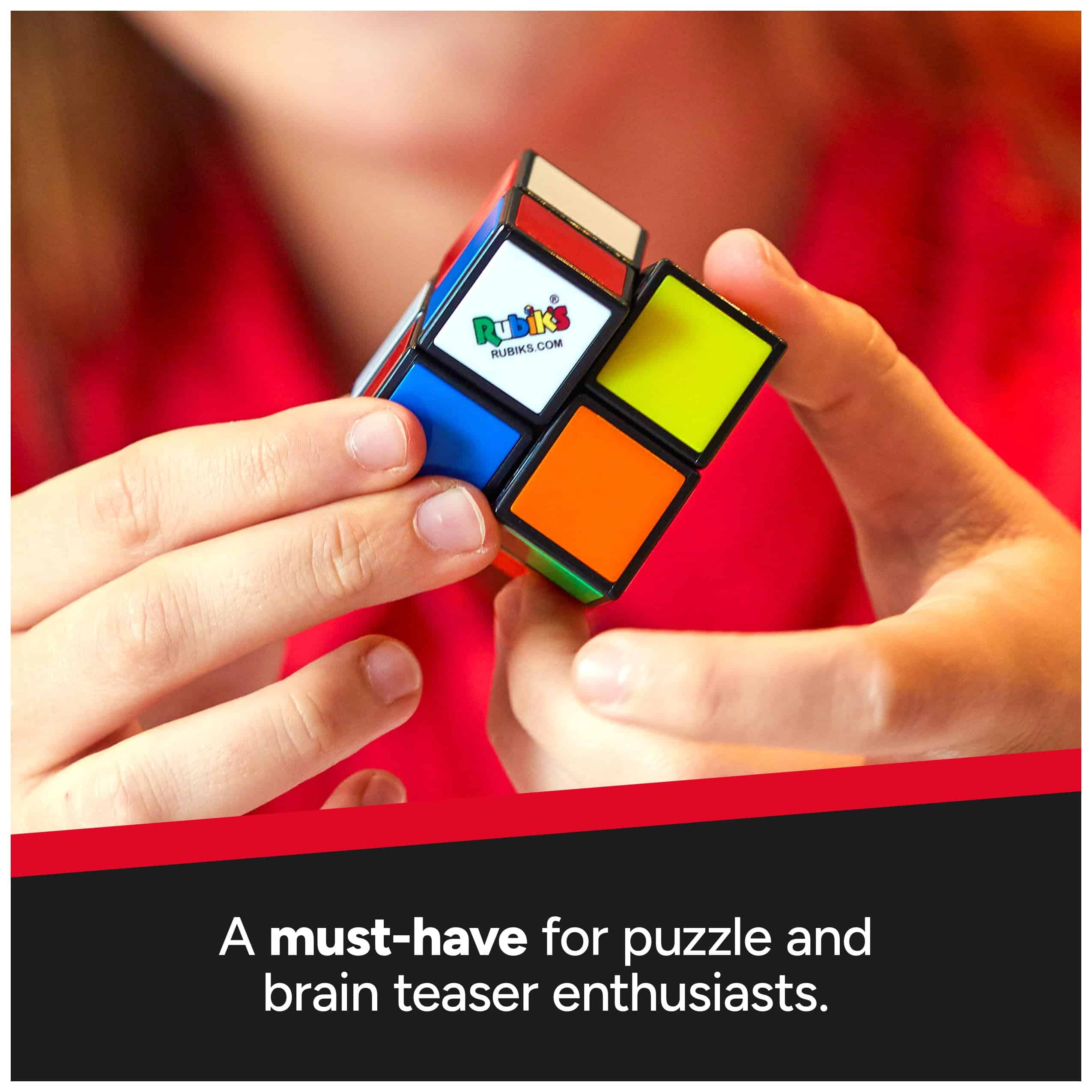 Hands holding a classic Rubiks Cube in vibrant colors, emphasizing puzzle-solving fun.