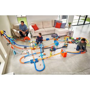Colorful toy race track in a cozy living room with children enjoying family playtime.