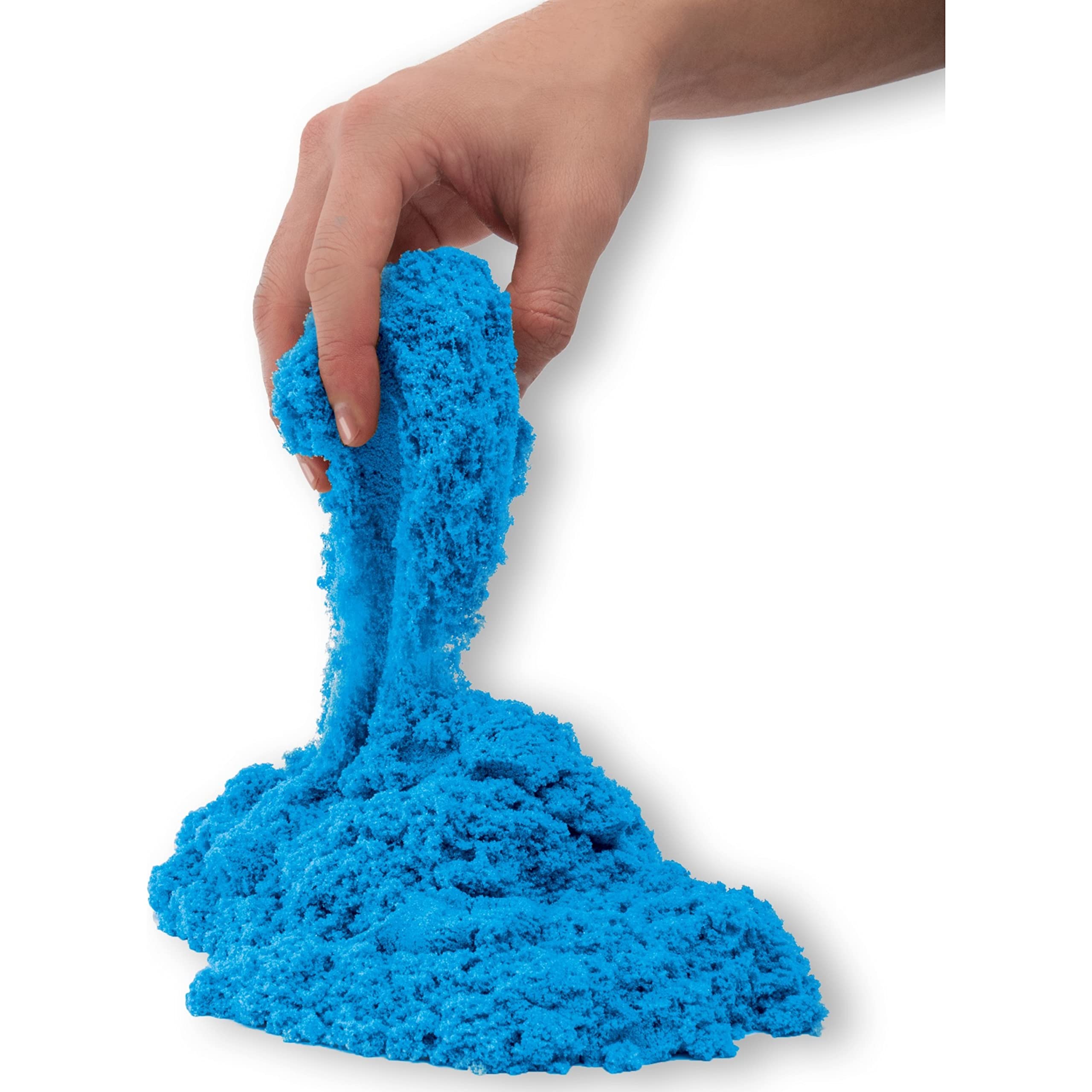 Playful hand manipulating vibrant blue kinetic sand against a clean white background.