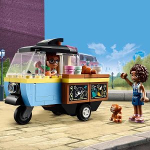 Joyful food cart scene with a friendly woman, dog, and excited girl on a sunny street.