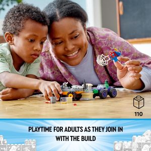 Joyful playtime: a child and adult bonding through creative building with colorful construction toys.