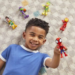 Young boy delights in play with Spider-Man and colorful action figures on a patterned surface.