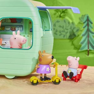 Joyful pig and playful dog enjoy adventures in a vibrant caravan playground setting.