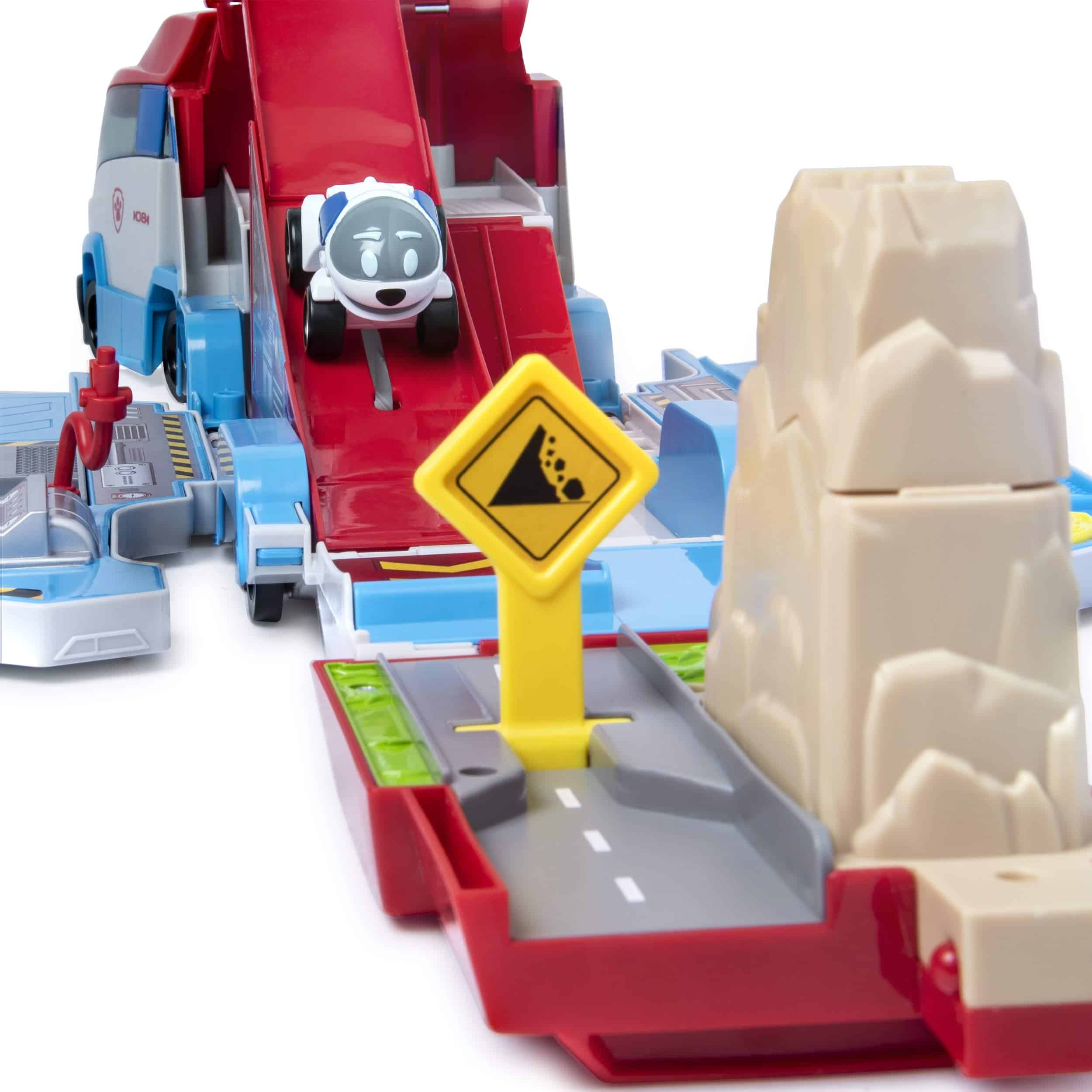 Exciting kids playset with slide, dog vehicle, caution sign, and rocky adventure landscape.