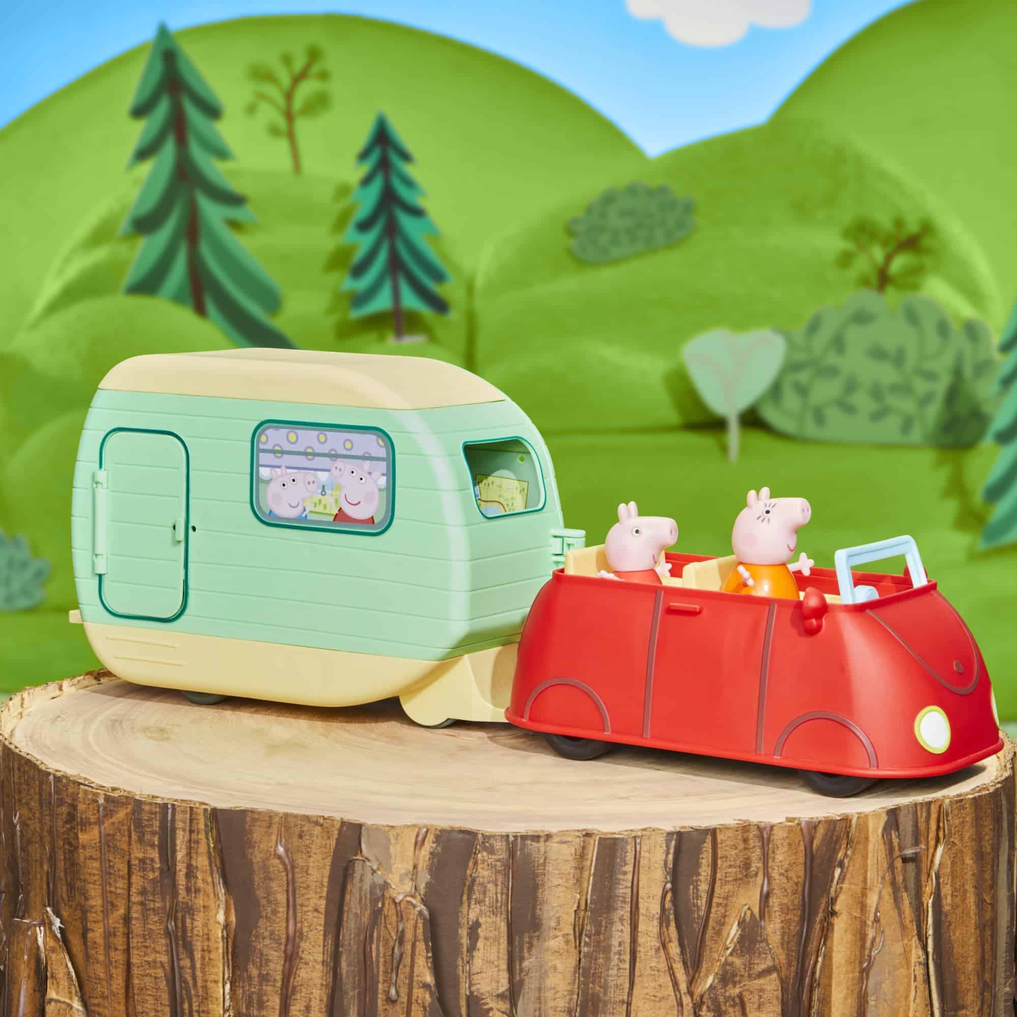 Whimsical toy scene of a colorful caravan and convertible in a vibrant outdoor setting.
