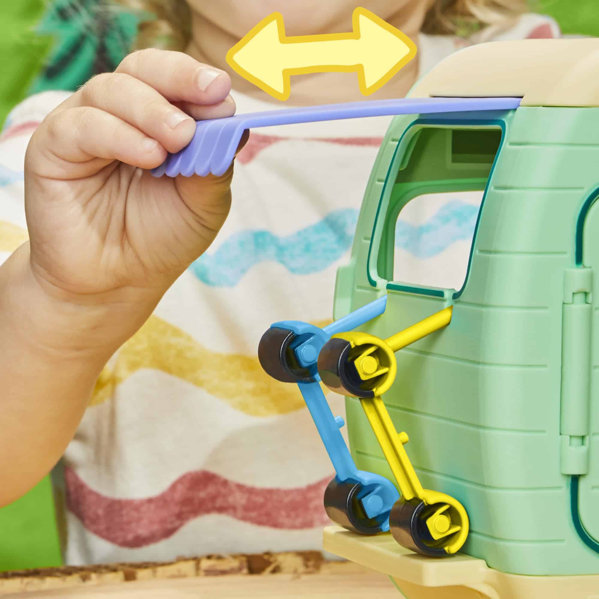 Child playing with a colorful building toy outdoors, fostering creativity and hands-on learning.