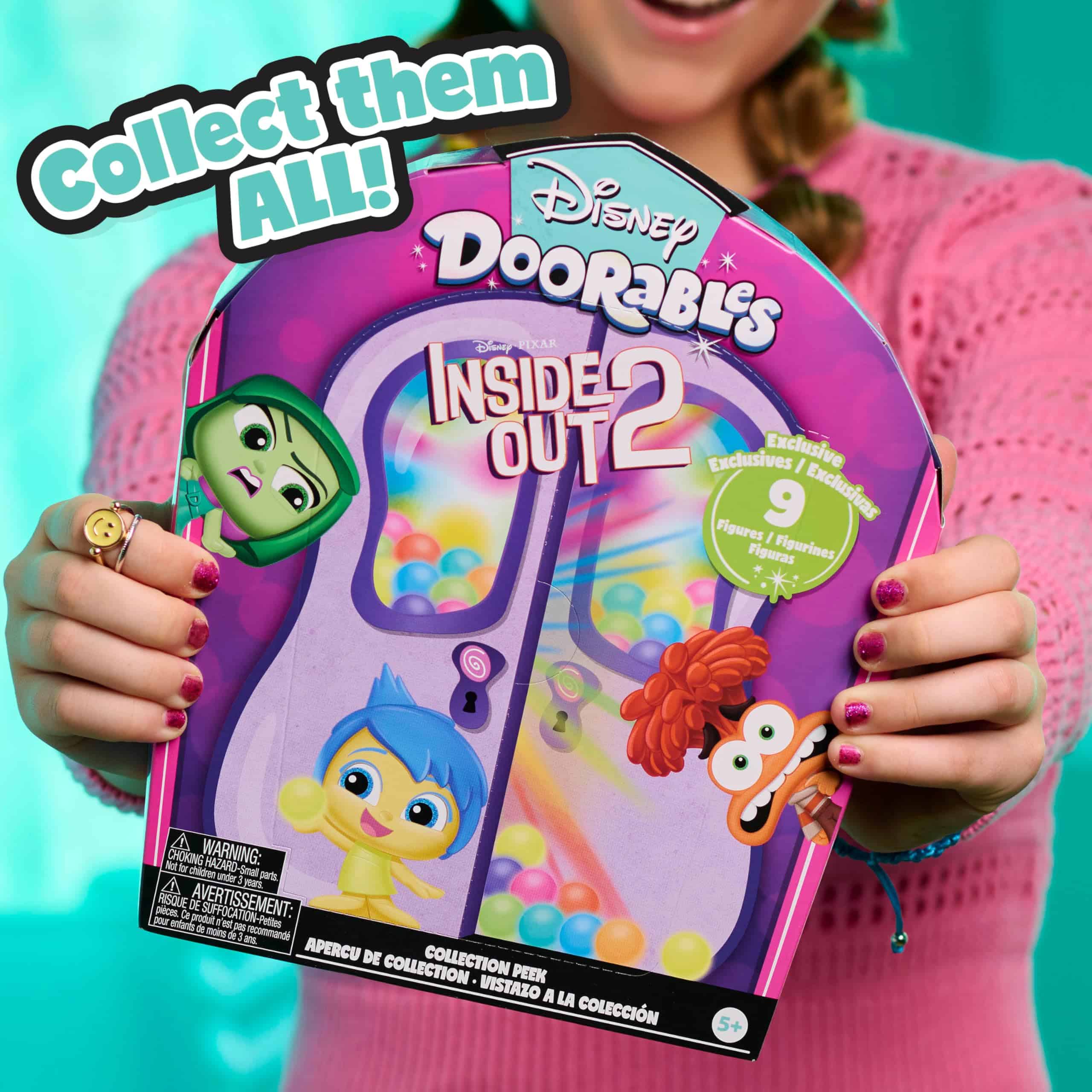 Joyful youth showcases vibrant Disney Doorables Inside Out 2 collection against a bright backdrop.