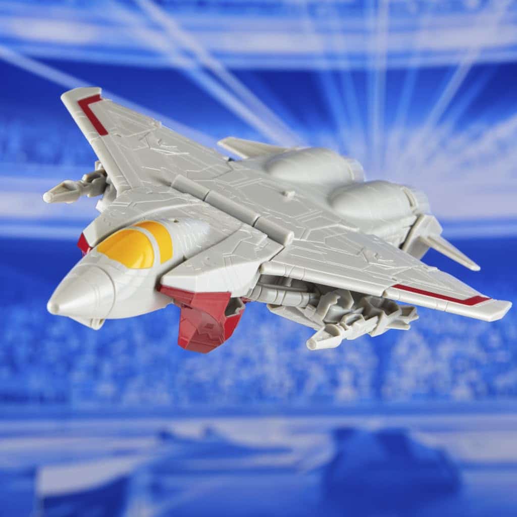 Sleek futuristic fighter jet model with red accents and yellow cockpit against a vibrant blue backdrop.