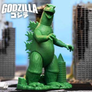 Vibrant Godzilla action figure dominates urban ruins in striking pose, showcasing its iconic power.