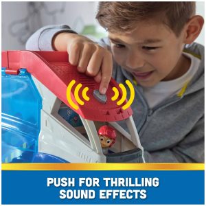 Young boy excitedly interacts with colorful adventure toy, ready to activate fun sound effects.