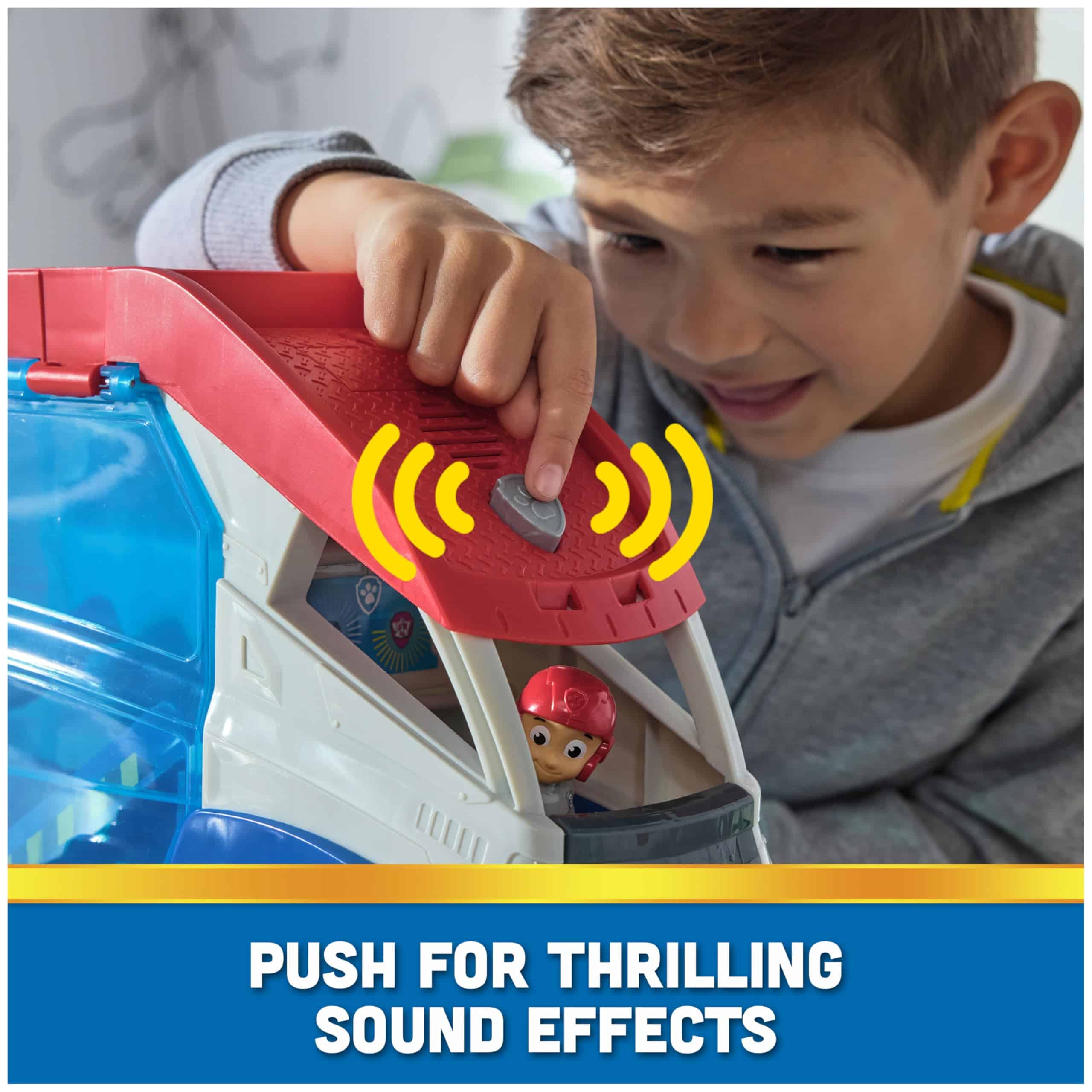 Young boy excitedly interacts with colorful adventure toy, ready to activate fun sound effects.