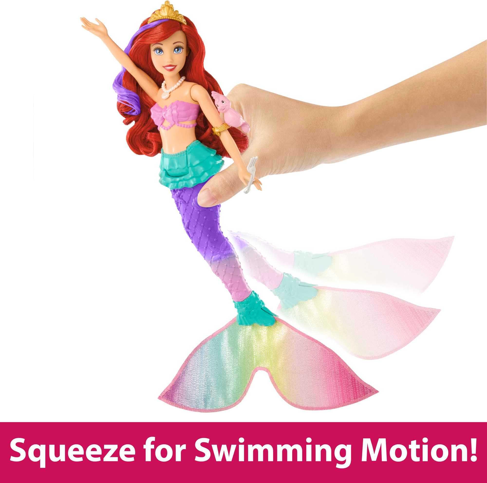 Vibrant mermaid doll with red hair and squeeze action for imaginative swimming play.