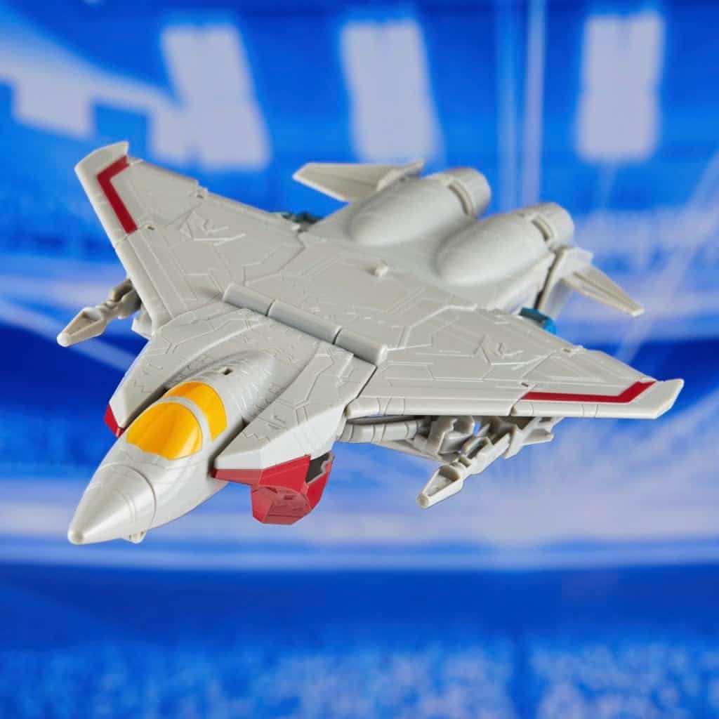 Sleek silver fighter jet toy with vibrant accents soaring in a dynamic arena backdrop.