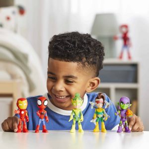 Young boy joyfully plays with colorful superhero action figures in a cozy room.