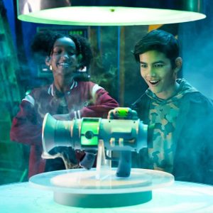Kids explore a futuristic gadget in an interactive exhibit, filled with awe and excitement.