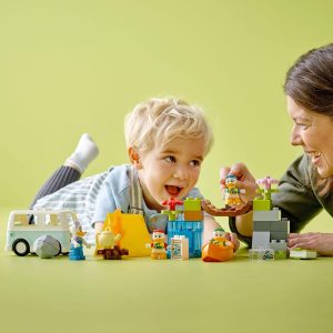 Child and adult joyfully build colorful structures together, fostering creativity and connection.