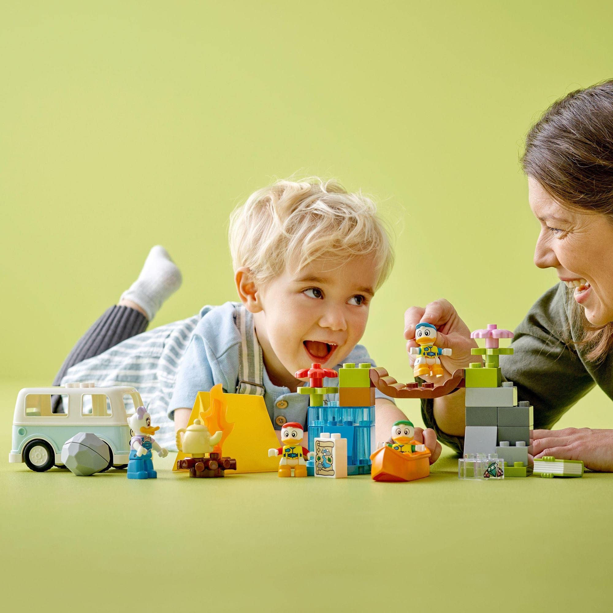 Child and adult joyfully build colorful structures together, fostering creativity and connection.