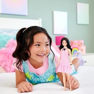 Young girl joyfully plays with a doll in a colorful, pastel-themed playroom.