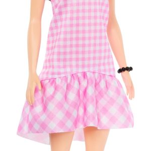 Charming pink gingham doll with bow, perfect for imaginative play and nostalgic display.