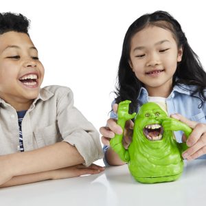 Children joyfully play with a vibrant green toy, capturing the essence of childhood imagination.