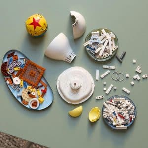 Colorful LEGO collection sparks creativity on a minimalist green surface with playful elements.