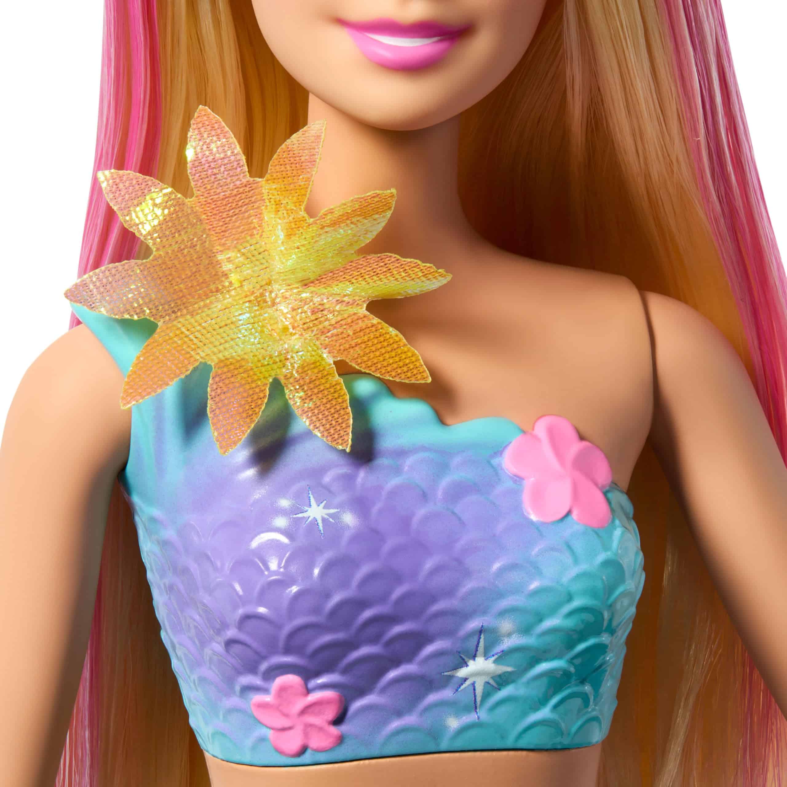 Vibrant mermaid doll with colorful top and cheerful expression, perfect for imaginative play.