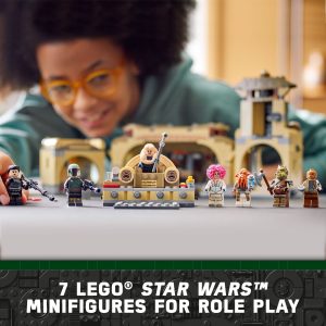 Child plays with colorful LEGO Star Wars minifigures in a detailed themed playset.