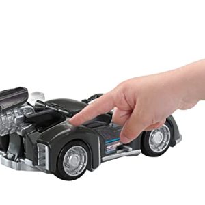 Sleek black Batman toy car sparks imaginative play as a child reaches out to engage.