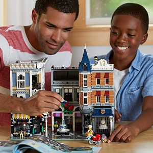Father and son joyfully build a vibrant Lego town scene, fostering creativity and teamwork.