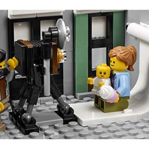 Vintage LEGO photography studio scene with a smiling mother, baby, and classic camera setup.
